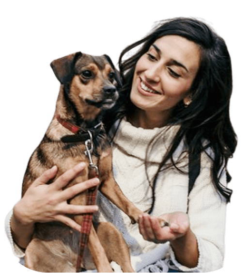 Woman holding and hugging a dog lovingly